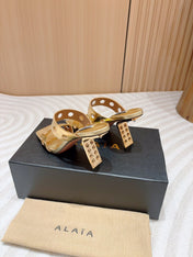 ALAIA TWO-STRAPS HIGH HEEL SANDALS IN GOLDEN PATENT LAMBSKIN