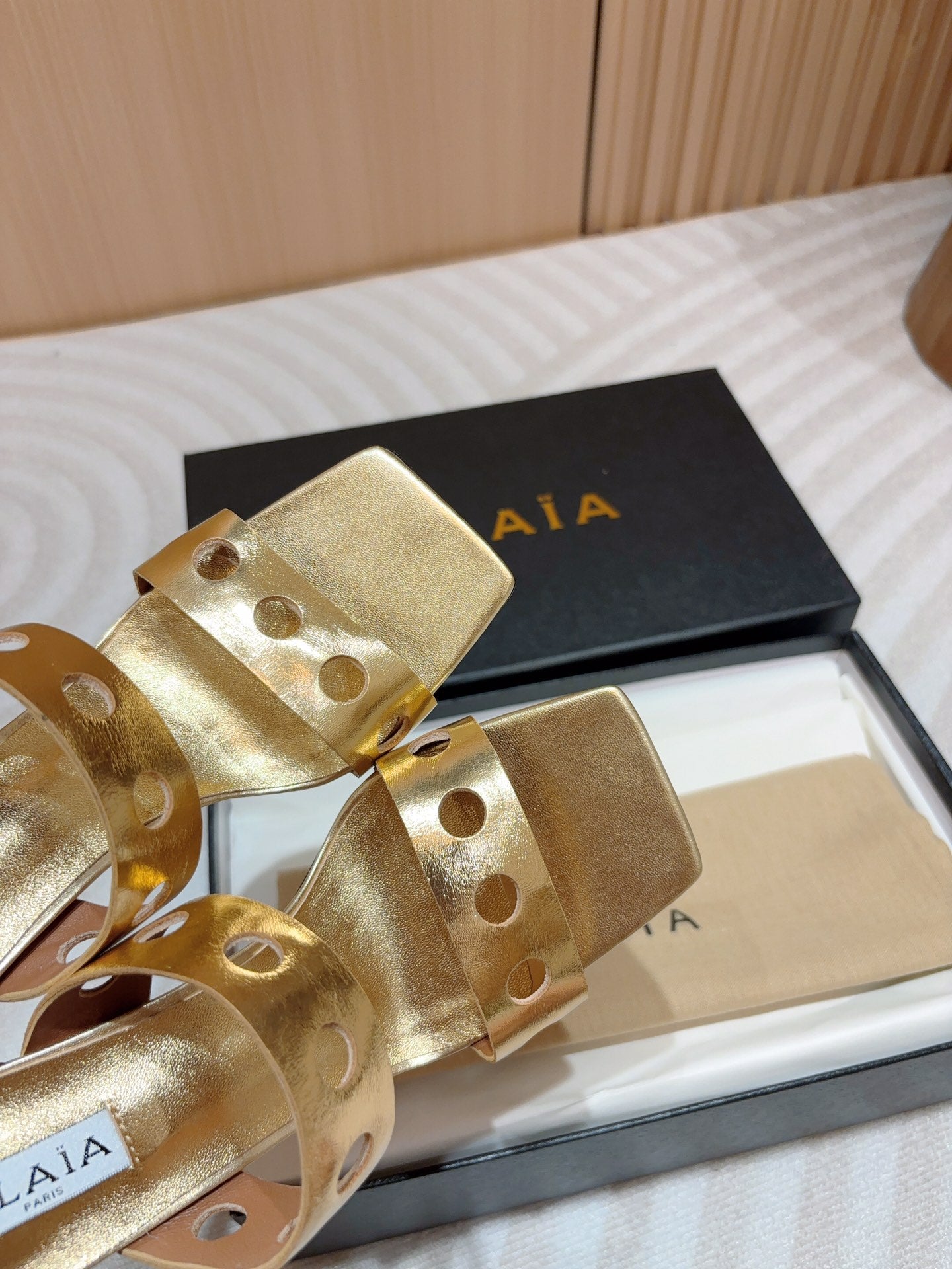 ALAIA TWO-STRAPS HIGH HEEL SANDALS IN GOLDEN PATENT LAMBSKIN