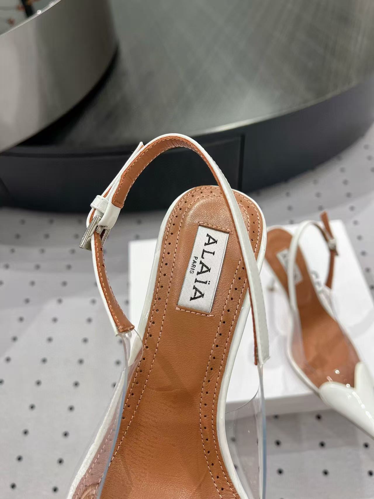 ALAIA HIGH 9 CM SLINGBACK IN WHITE PATENT CALFSKIN AND FILM