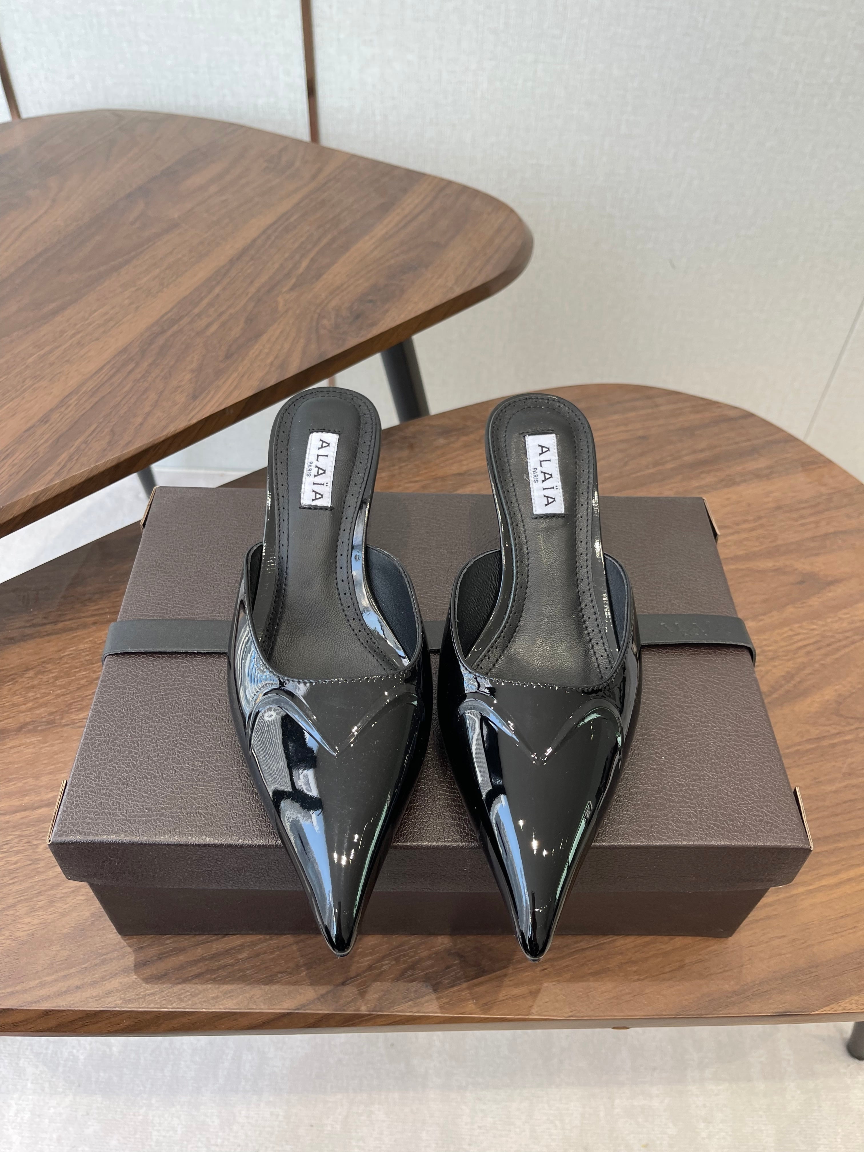 ALAIA 26S HEELED MULES 50 MM IN BLACK GLOSSY CALFSKIN