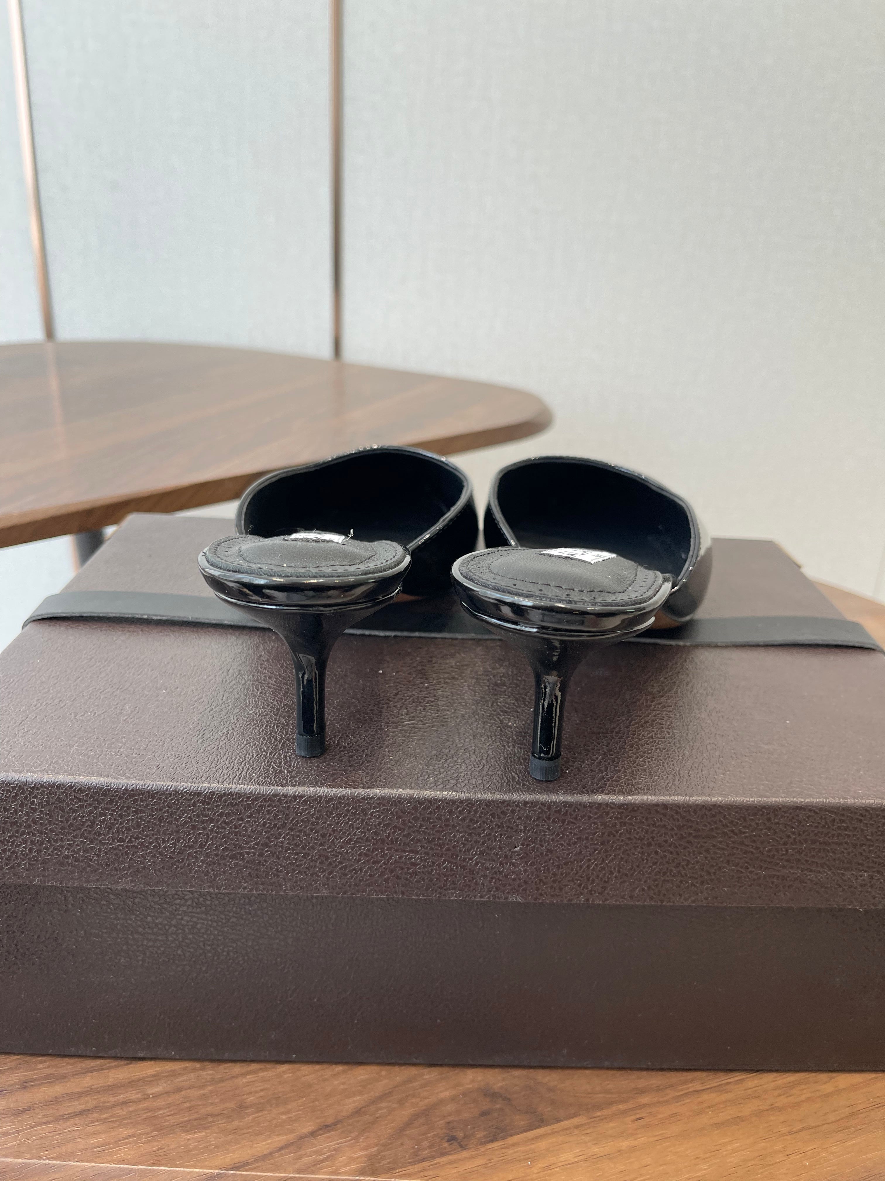 ALAIA 26S HEELED MULES 50 MM IN BLACK GLOSSY CALFSKIN