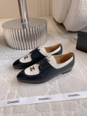 CHANEL 25S TWO TONE LACE UP IN BLACK AND WHITE CALFSKIN