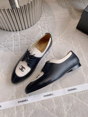 CHANEL 25S TWO TONE LACE UP IN BLACK AND WHITE CALFSKIN