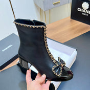 CHANEL 25S HEELED CHAIN BOOTS WITH BOW IN BLACK CALFSKIN GOLD HARDWARE