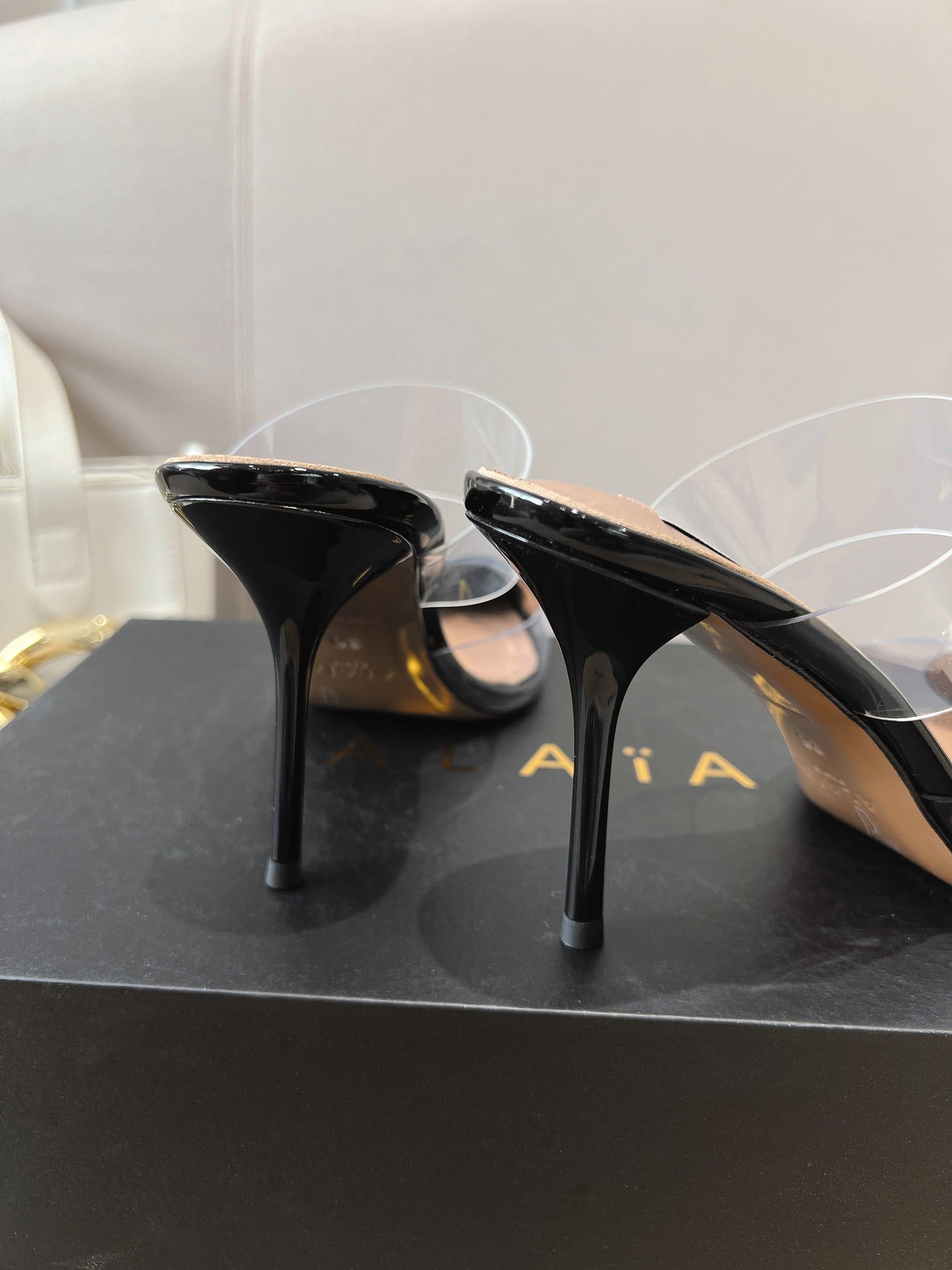 ALAIA HIGH MULES IN BLACK PATENT CALFSKIN AND FILM