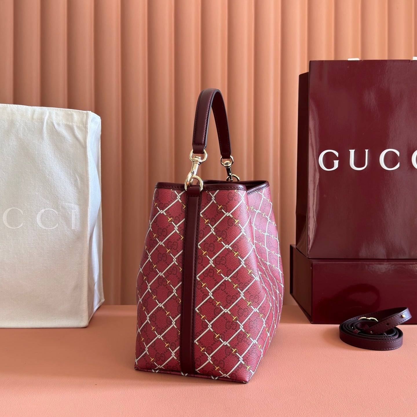 GUCCI 26S GG EMBLEM BUCKET BAG 25 IN DARK RED COATED FABRIC