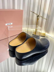 MIUMIU 26S CLOG MULES IN BLACK CALFSKIN
