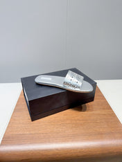 ALAIA FLAT SANDALS WITH PERFORATED STRAPS 25S IN SILVER LAMBSKIN