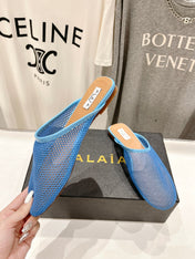 ALAIA FLAT MULES IN CERULEAN BLUE MESH FISHNET