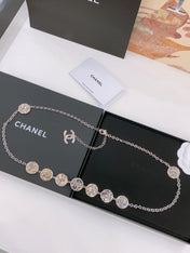 TWISTED CHAIN BELT WITH RHINESTONES AND LOGO PLATE IN SILVER TONE
